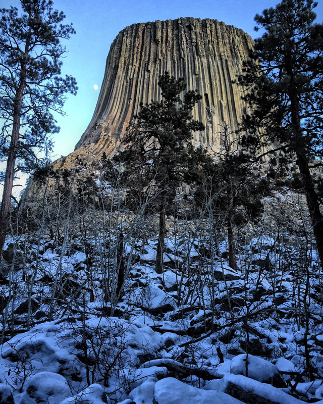 Devils Tower at day with the moon showing